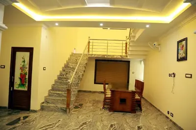 a staircase in a room with a table and a stair case at 3 BHK HOUSE with nice facilities,Gate&Fence in Kunnamangalam
