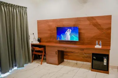 a television on a wooden desk in a room at Ethnic Villa Wayanad in Kenichira