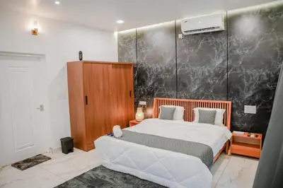 a bedroom with a bed and a wall at Ethnic Villa Wayanad in Kenichira