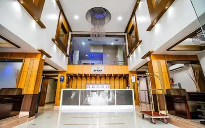a large room with a table and chairs in it at Hotel Afrad International in Kondotti