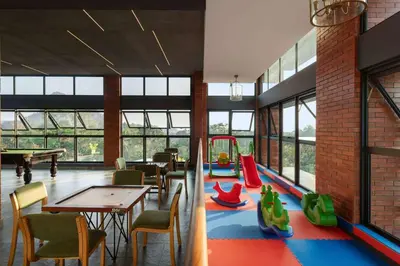 a restaurant with a table and chairs and a playground at Morickap Lord's 83, Trademark Collection by Wyndham in Meenangadi