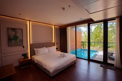 a bedroom with a bed and a swimming pool at Morickap Lord's 83, Trademark Collection by Wyndham in Meenangadi