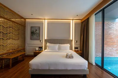 a bedroom with a bed with two wedding shoes on it at Morickap Lord's 83, Trademark Collection by Wyndham in Meenangadi