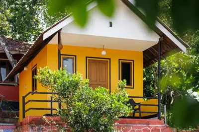 a yellow house with a white roof at Birds Island Ayur-Yoga Retreat in Ernakulam