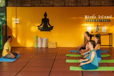 a group of people sitting in a yoga class at Birds Island Ayur-Yoga Retreat in Ernakulam