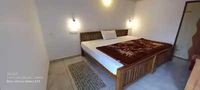 a small bedroom with a bed in a room at Perumaal Homestay in Munnar