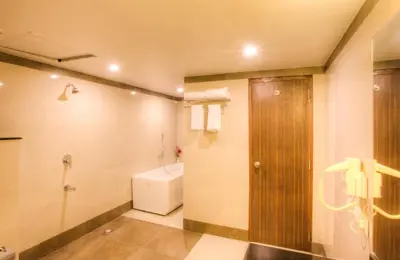 a bathroom with a toilet and a sink and a shower at The Atrium Boutique Hotel in Mysore