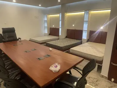 a conference room with a table and chairs and beds at GH Grand Park in Angamali