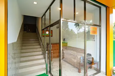 an entrance to a building with glass doors and stairs at GH Grand Park in Angamali