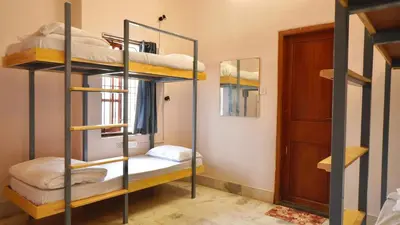 a room with bunk beds and a door at Roambay - Gokulam in Mysore