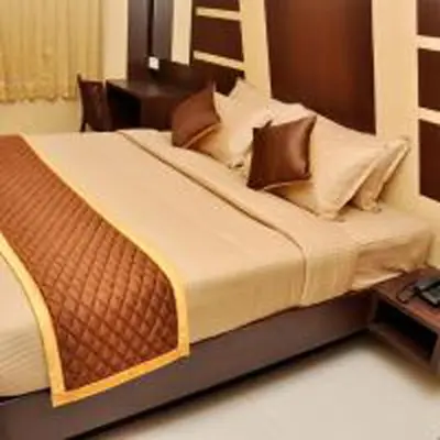 a bedroom with a large bed with pillows on it at Harikrishna Park in Coimbatore