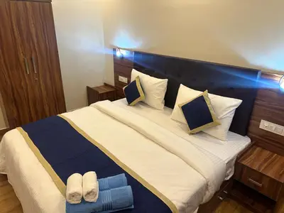 a bedroom with a large bed with slippers on it at Golden hills cottage in Viripara