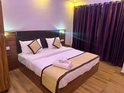 a bedroom with a bed with two towels on it at Golden hills cottage in Viripara