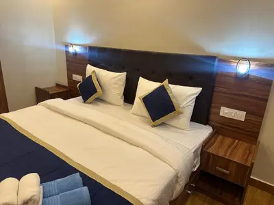 a bedroom with a large bed with white sheets and pillows at Golden hills cottage in Viripara
