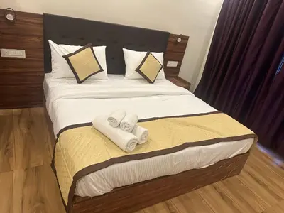 a bedroom with a bed with two towels on it at Golden hills cottage in Viripara