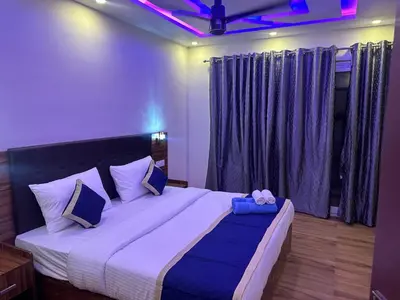a bedroom with a large bed with purple curtains at Golden hills cottage in Viripara
