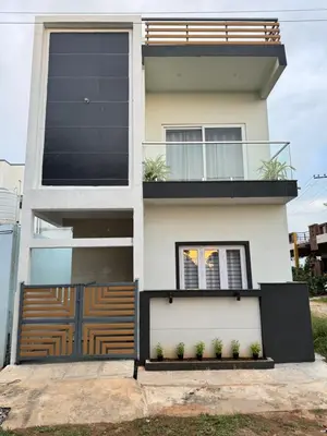 a house with a gate and a fence at Stayover Homestay in Mysore
