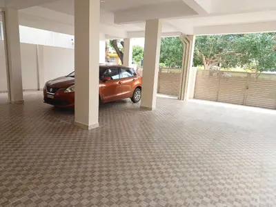 a car parked inside of a house with a garage at Sapna residency in Mettuppālaiyam