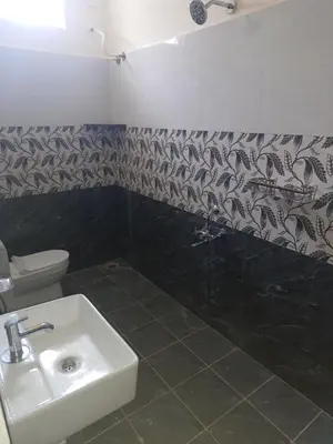 a bathroom with a sink and a toilet at Sapna residency in Mettuppālaiyam
