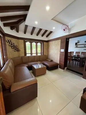 a living room with a couch and a table at Le Casabella in Kalpetta