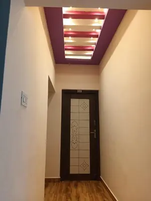 a hallway with a door and a ceiling with a light at KPR Residency Near Isha - Adiyogi in Alāndurai