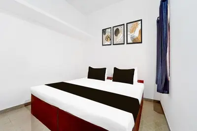 a bedroom with a large white bed in a room at Scott legacy apartment in Kulattūr