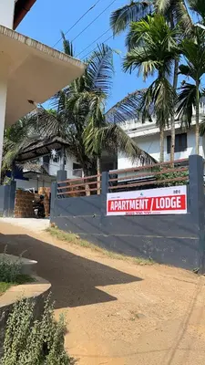 a sign on a wall in front of a building at Scott legacy in Kulattūr