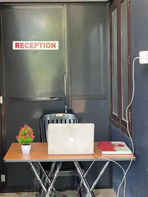 a table with a laptop computer on top of it at Scott legacy in Kulattūr