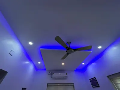 a ceiling with a ceiling fan and blue lights at Puzhayoram Homestay in Trichūr