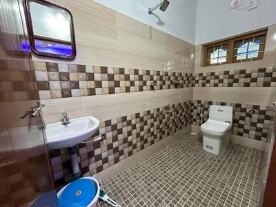 a bathroom with a sink and a toilet at Puzhayoram Homestay in Trichūr