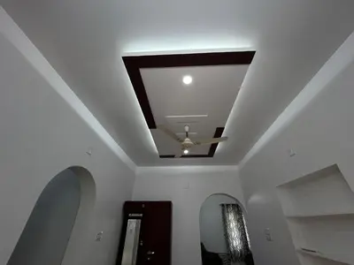 a coffered ceiling with a ceiling fan in a hallway at Puzhayoram Homestay in Trichūr