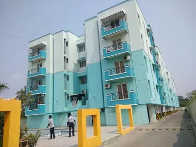 a building with two men standing in front of it at Gerones Residency Serviced Apartments & Home Stays in Coimbatore
