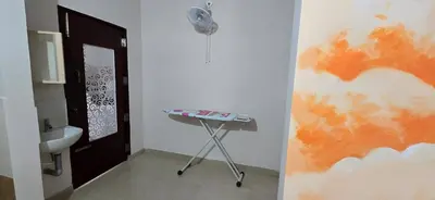 a bathroom with a sink and a table next to a door at PPH Living Arvind Inn in Coimbatore