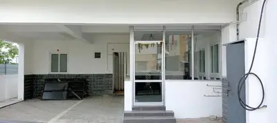 an open glass door of a house with a fireplace at PPH Living Arvind Inn in Coimbatore