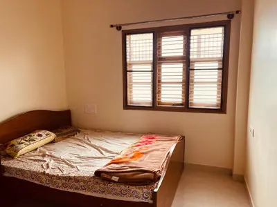 a bed in a room with a window at A B House in Kollegālam