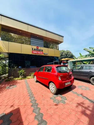 a red car parked in front of a building at familyvillasliesure in Padinjarathara