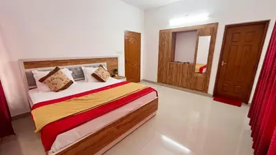 a bedroom with a bed and a window and a door at Green Nest Villa at Athirappilly in Athirappilly