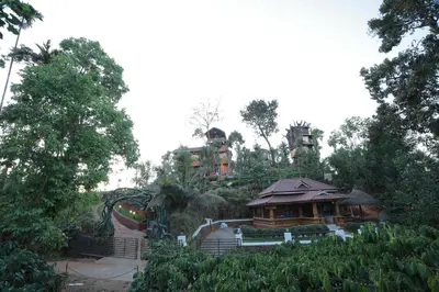 a house on top of a hill with a building at Blue Bell Resort in Periya