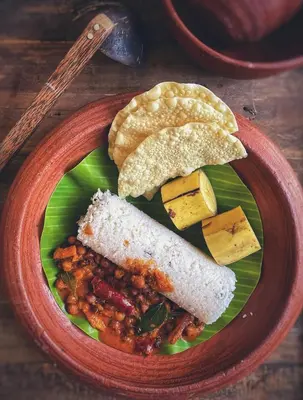 a plate of food with bread and beans and cheese at Blue Bell Resort in Periya