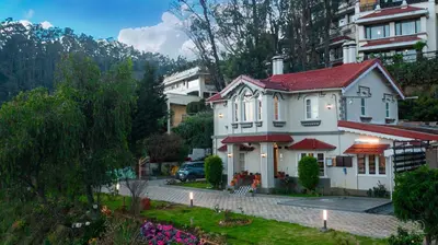 a white house with a red roof at The Humming Bird A Stay Chapter in Ooty