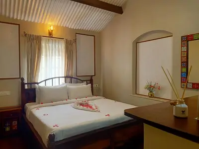 a bedroom with a bed with flowers on it at The Humming Bird A Stay Chapter in Ooty