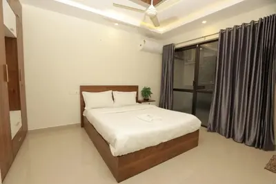 a bedroom with a bed and a window at VVP service Apartments in Nedumbassery