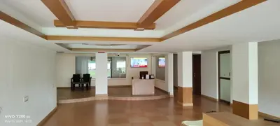 an empty lobby with white walls and wooden ceilings at VVP service Apartments in Nedumbassery