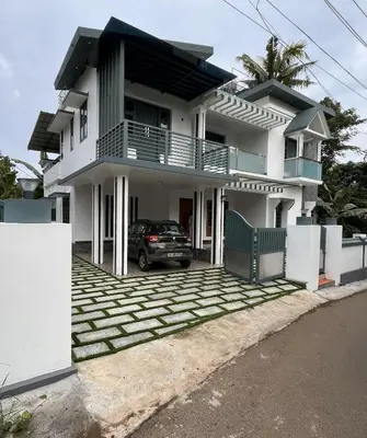 a house with a car parked in front of it at Dutch Heaven - Luxury Rental Villa Near Cochin Airport in Nedumbassery