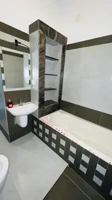 a bathroom with a sink and a tub and a toilet at Dutch Heaven - Luxury Rental Villa Near Cochin Airport in Nedumbassery