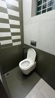 a bathroom with a white toilet in a stall at Dutch Heaven - Luxury Rental Villa Near Cochin Airport in Nedumbassery