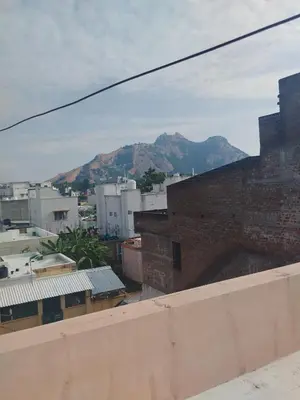 a view of a city with mountains in the background at Kumarasamy House in Tiruchengodu