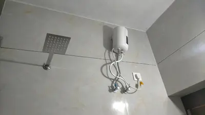 a light hanging from the ceiling of a room at Signature by Rayhan in Vālpārai