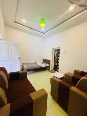 a living room with a couch and a bed at 7FORT HOMESTAY Athirappilly in Athirappilly