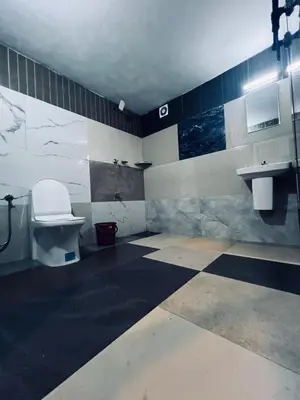 a bathroom with a toilet and a sink at 7FORT HOMESTAY Athirappilly in Athirappilly